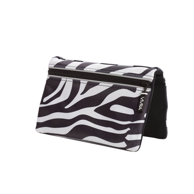  Bi-fold belt-less magnetic bum bag made of neoprene fabric in a black and white zebra print.  Waist bag contains 4 concealed magnets – one in each corner to secure to any waist band.