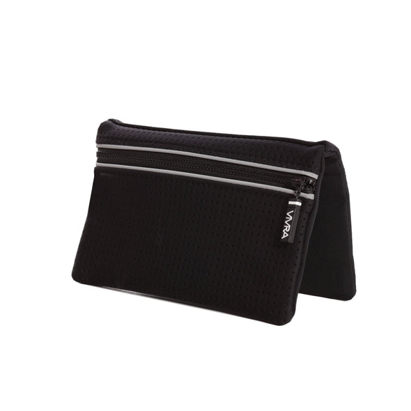 Bi-fold belt-less magnetic bum bag made of neoprene fabric in plain black block colour. Neoprene has a perforated sporty design aesthetic.  Waist bag contains 4 concealed magnets – one in each corner to secure to any waist band.