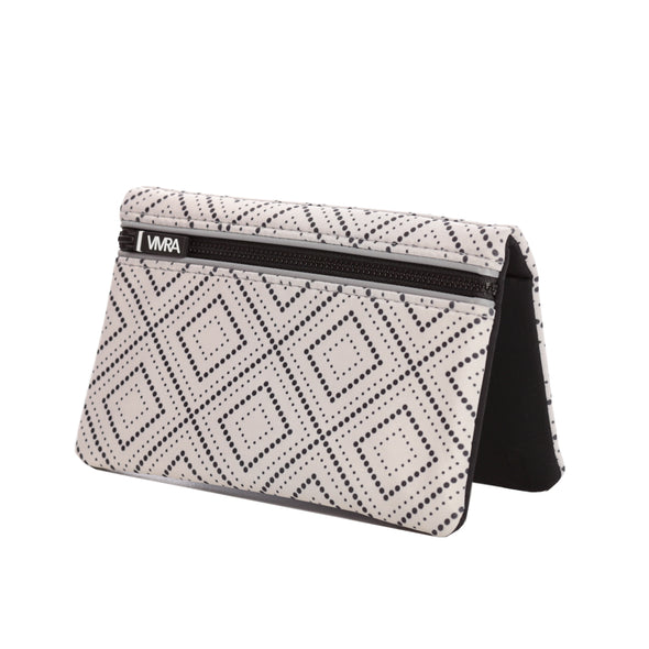 Bi-fold belt-less magnetic bum bag made of neoprene fabric in a grey/beige undertone with a black dotted geometric print.  Waist bag contains 4 concealed magnets – one in each corner to secure to any waist band.