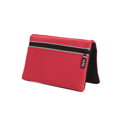 Bi-fold belt-less magnetic bum bag made of neoprene fabric in bold red block colour. Neoprene has a perforated sporty design aesthetic.  Waist bag contains 4 concealed magnets – one in each corner to secure to any waist band.
